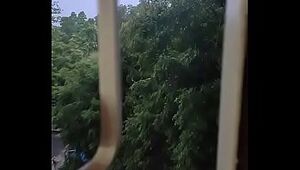 Husband fucking wife in doggy style by enjoying the rain from window